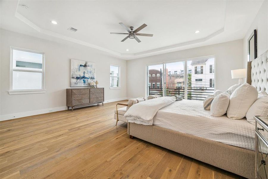 Primary suite features elegant crown molding ceiling and is bathed in natural light.