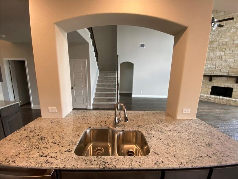 Huge granite kitchen island offers a fantastic workspace