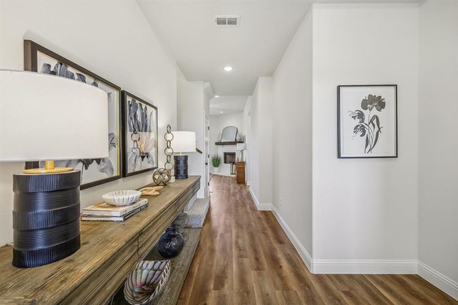 Living room with a fireplace, ceiling fan, and wood-type flooring