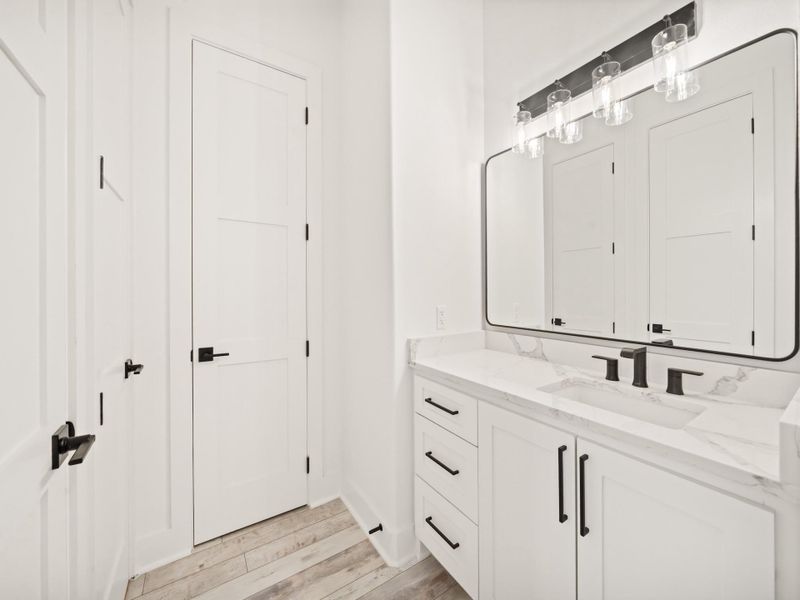 Second Floor Vanity across from private stand up shower and commode.