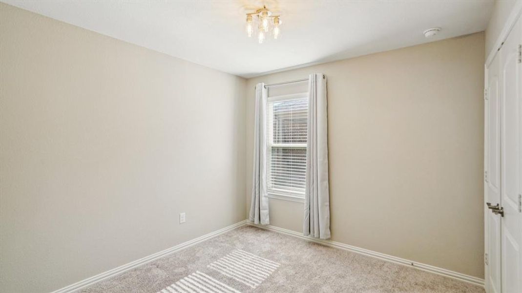 Unfurnished room with carpet and baseboards Unfurnished room with carpet and baseboards