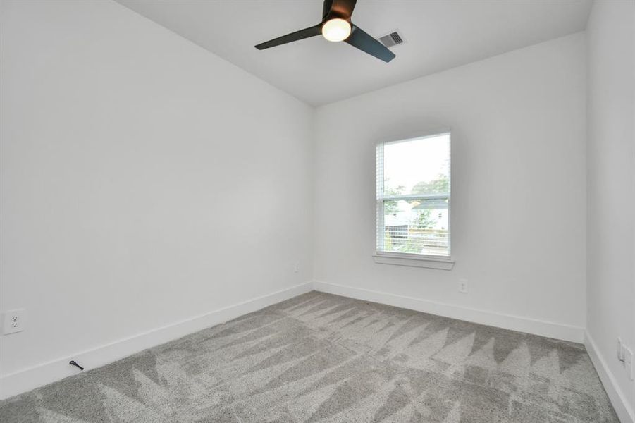 Unwind in the comfort of this inviting second of 2 guest bedrooms, featuring elegant ceiling fan, walk in closet, plus carpeted floor and abundant natural light