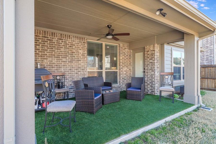View of patio with a ceiling fan and outdoor seating
