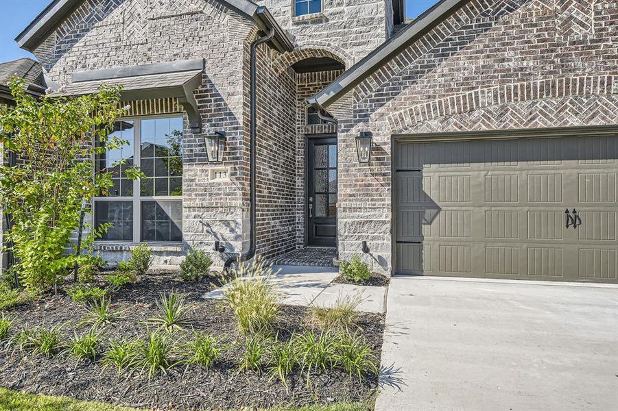 Doorway to property featuring a garage