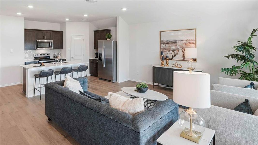 Living area featuring light wood-type flooring and recessed lighting
