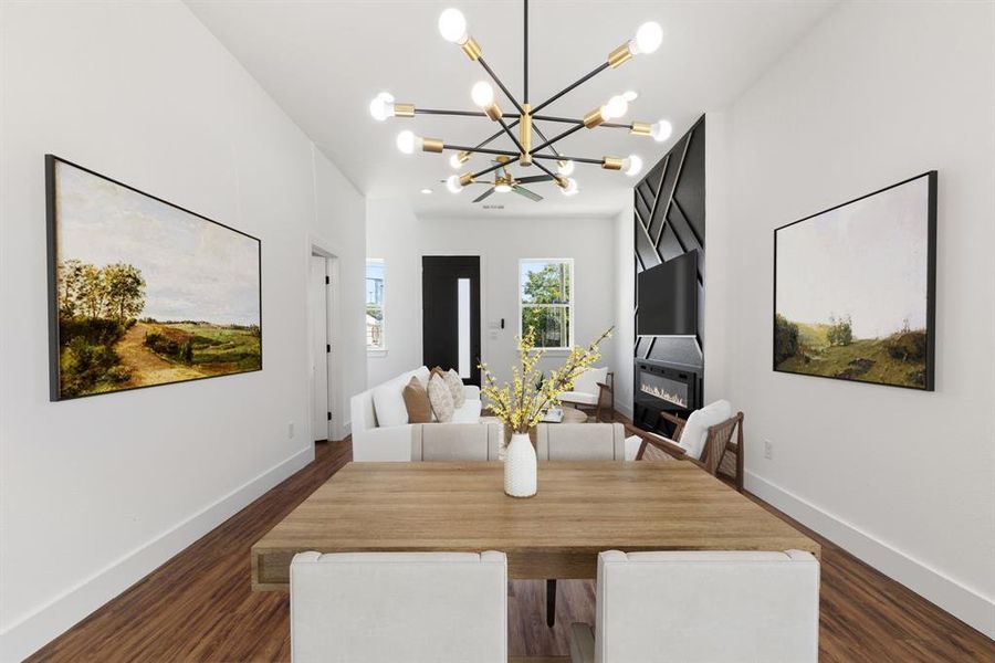 Dining space with a large fireplace, recessed lighting, dark wood-style flooring, and a chandelier