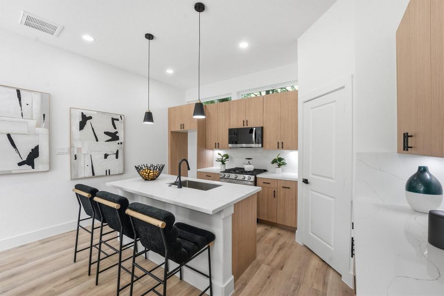 An abundance of cabinet space and upgraded stainless appliances with gas range.