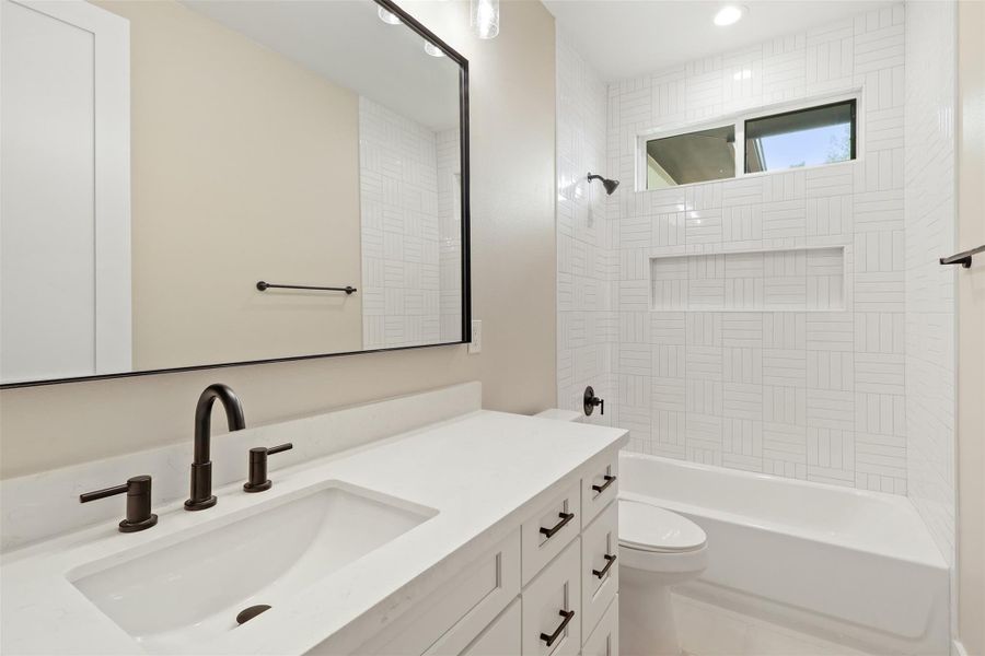 Bathroom featuring vanity, toilet, recessed lighting, and tub / shower combination Bathroom featuring vanity, toilet, recessed lighting, and tub / shower combination