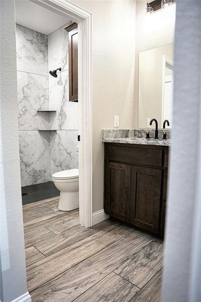 Ensuite Bath with dual sink vanity, lots of cabint space and a zero-curb tiled shower.