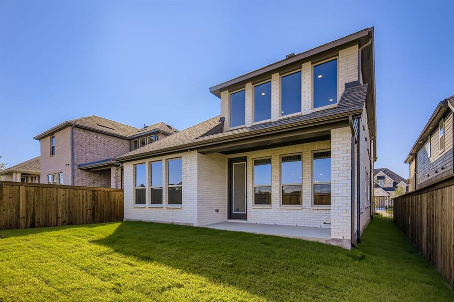 Back of property featuring brick siding, a fenced backyard, a patio, and a shingled roof Back of property featuring brick siding, a fenced backyard, a patio, and a shingled roof