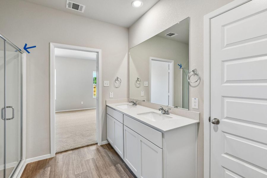 A spacious walk-in shower, elegant tilework, and premium fixtures offers a refreshing start to the day, while the soaking tub provides the perfect place to unwind in the evenings.