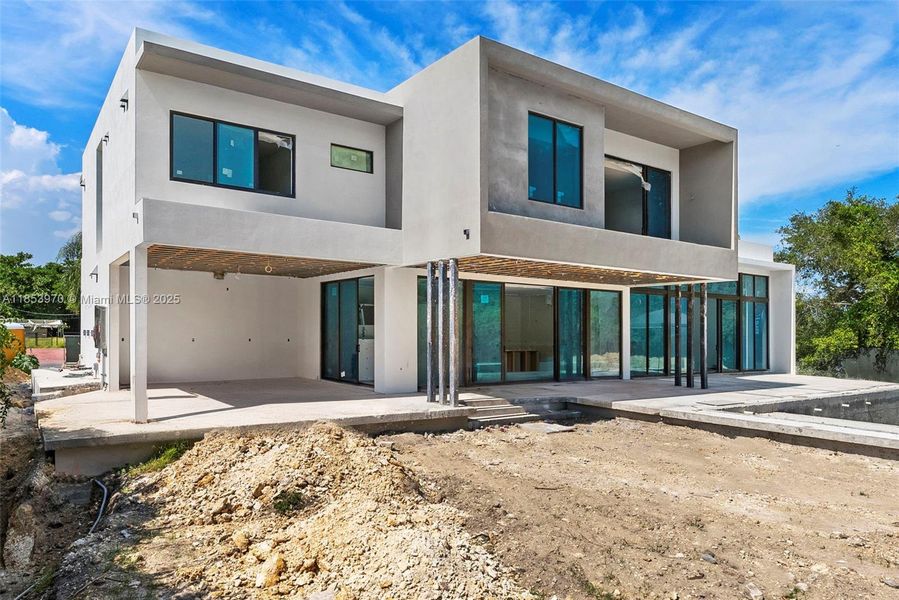 Front exterior of a new home in , Pinecrest, FL, highlighting curb appeal (Image 30). Front exterior of a new home in , Pinecrest, FL, highlighting curb appeal (Image 30).