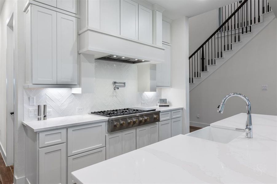 Beautiful farmhouse sink anchors the big island with seating for 4.  Note the ample storage ensuring a clutter-free and organized kitchen!