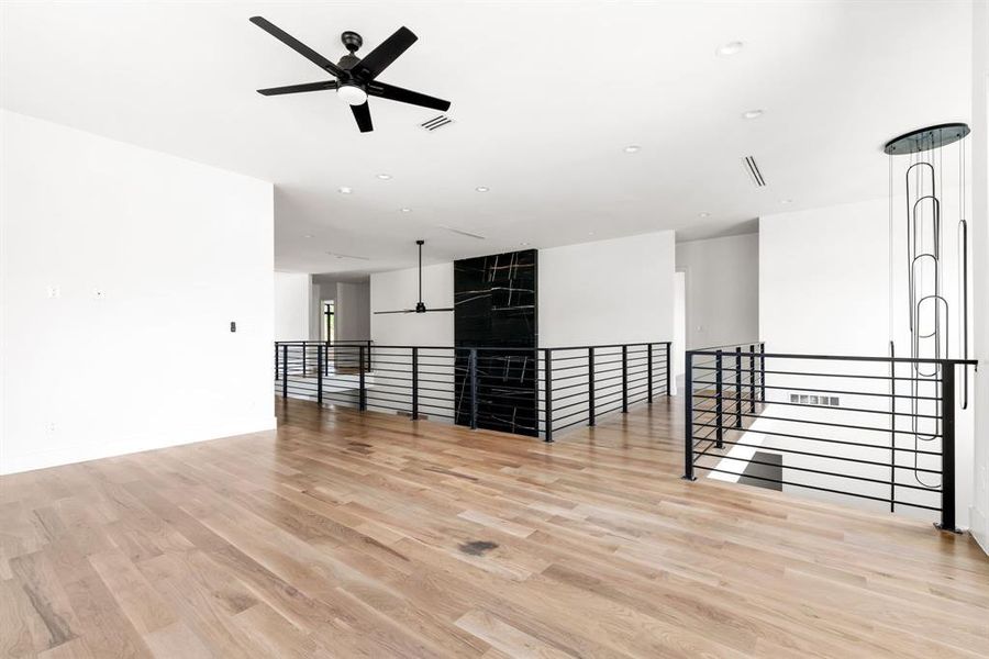 Unfurnished room with ceiling fan, light wood-type flooring, and recessed lighting Unfurnished room with ceiling fan, light wood-type flooring, and recessed lighting