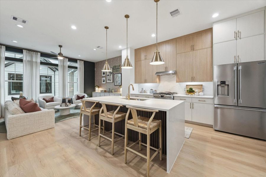 Chef’s kitchen with oversized island and premium cabinetry Chef’s kitchen with oversized island and premium cabinetry
