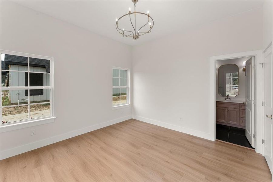 Unfurnished dining area with light wood-style floors and a chandelier