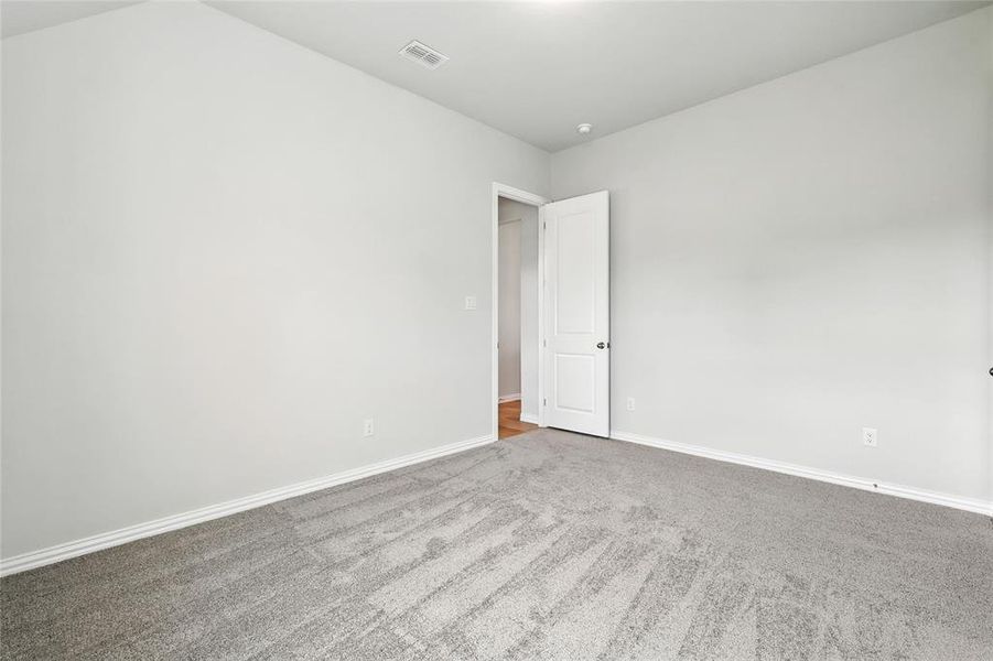 Carpeted empty room featuring baseboards Carpeted empty room featuring baseboards