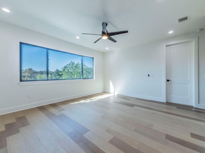 Unfurnished room with light wood finished floors, recessed lighting, and a ceiling fan Unfurnished room with light wood finished floors, recessed lighting, and a ceiling fan