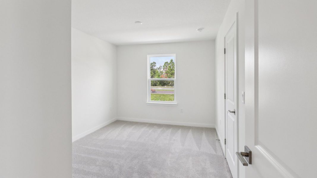 Guest Bedroom in the Monterey End Townhome by DRB Homes - Cyrene at Harmony in St Cloud FL