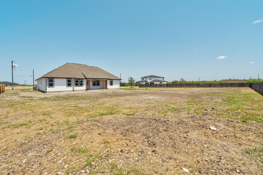 Rear view of property featuring a shingled roof Rear view of property featuring a shingled roof