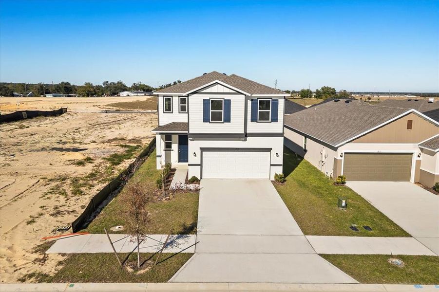 Front exterior of a new home in Robins Run, Lake Wales, FL, highlighting curb appeal (Image 1). Front exterior of a new home in Robins Run, Lake Wales, FL, highlighting curb appeal (Image 1).