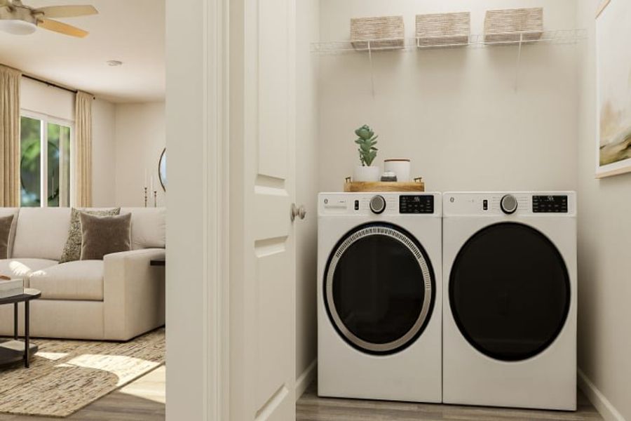A room with a washing machine and a couch.