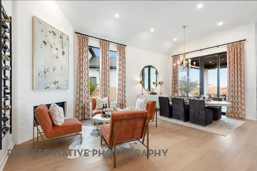 Living area featuring recessed lighting, wood finished floors, vaulted ceiling, and a fireplace