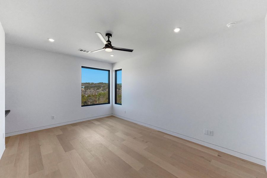 Unfurnished room with ceiling fan, light wood finished floors, and recessed lighting