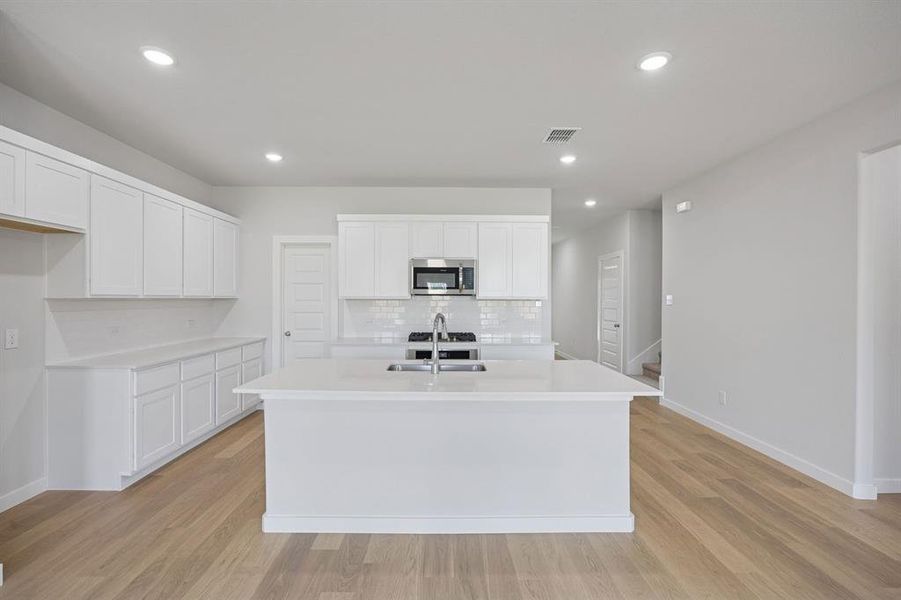 Kitchen in the Masters home plan by Trophy Signature Homes – REPRESENTATIVE PHOTO