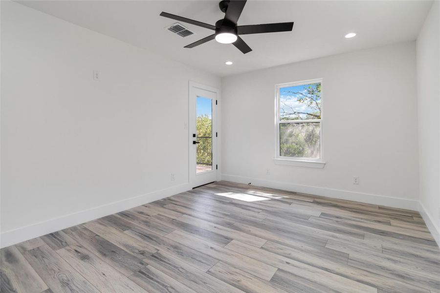 he primary bedroom on the main level offers direct access to a private deck for seamless indoor-outdoor living. he primary bedroom on the main level offers direct access to a private deck for seamless indoor-outdoor living.