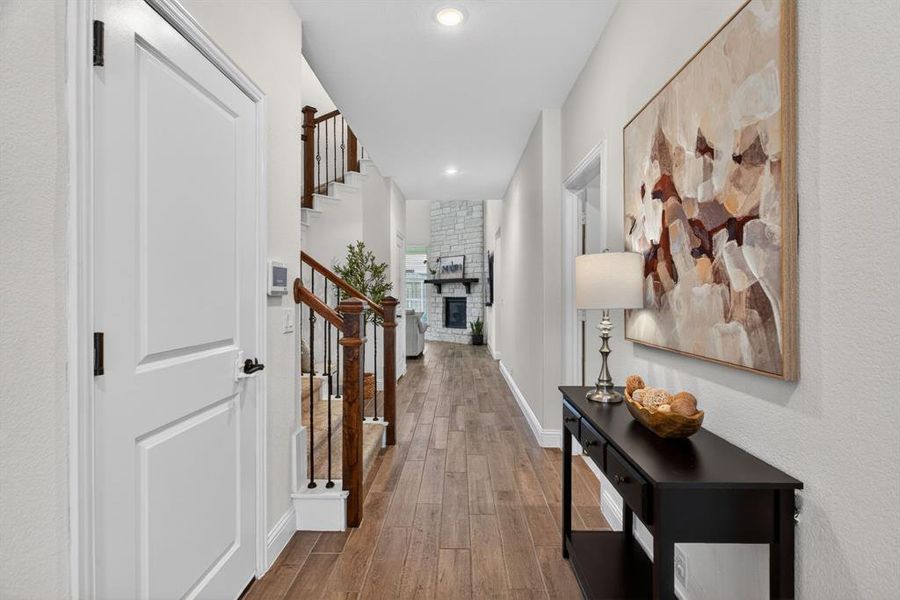 Walk past the downstairs guest suit and the laundry room into the two-story living room. Walk past the downstairs guest suit and the laundry room into the two-story living room.