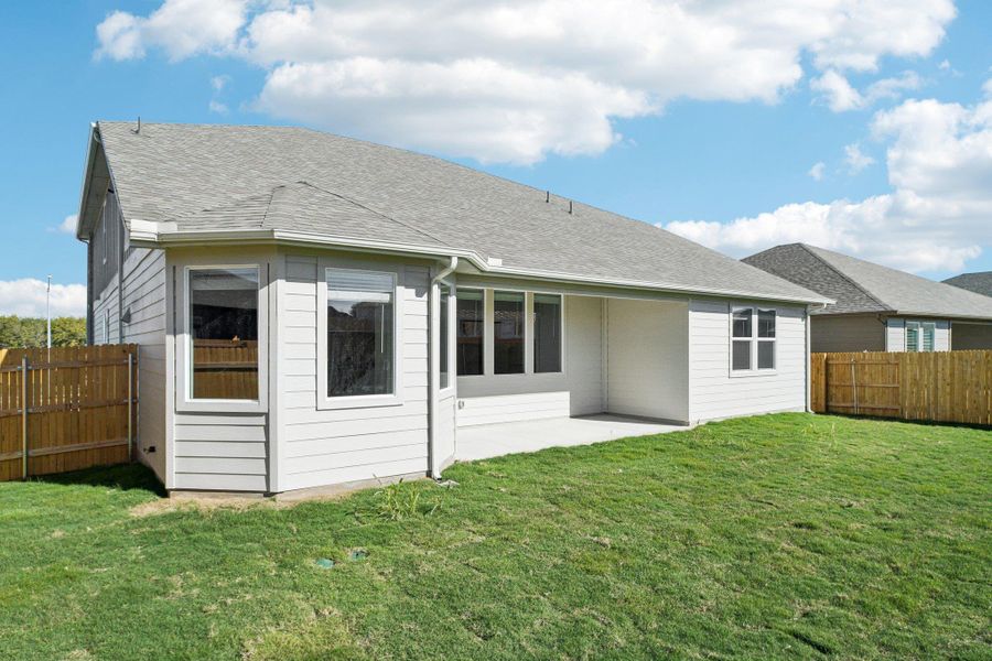 Back of house featuring a patio area, a fenced backyard, and roof with shingles