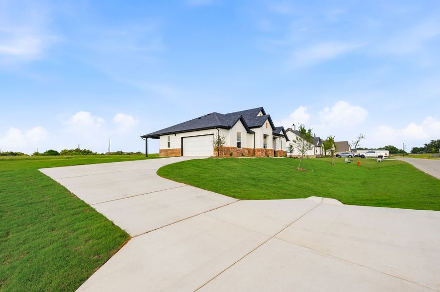Front exterior of a new home in Saddleback Estates, Boyd, TX, highlighting curb appeal (Image 24).