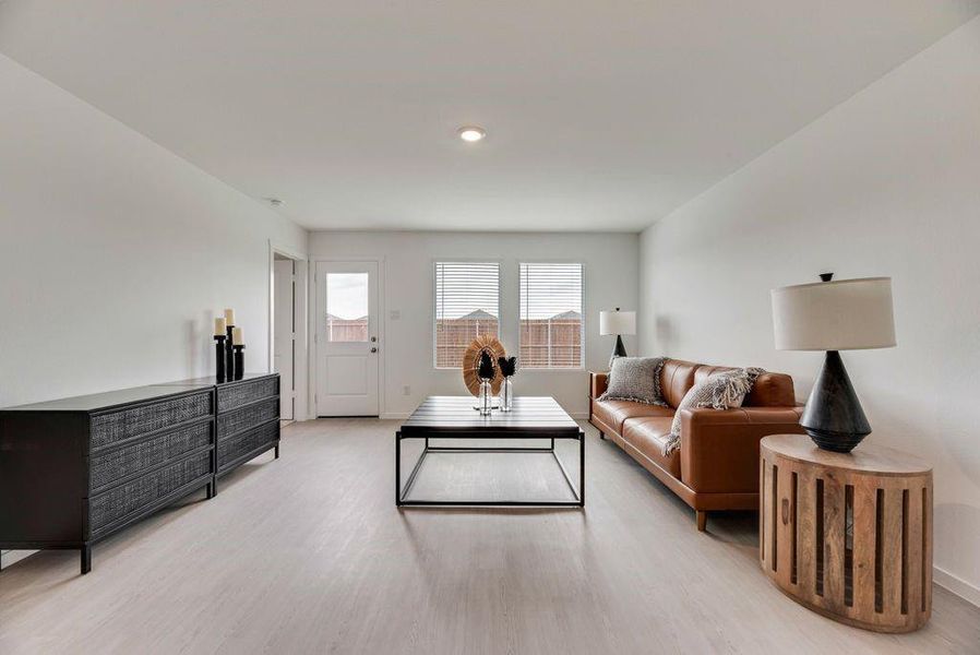 Living room with light wood-style floors and baseboards