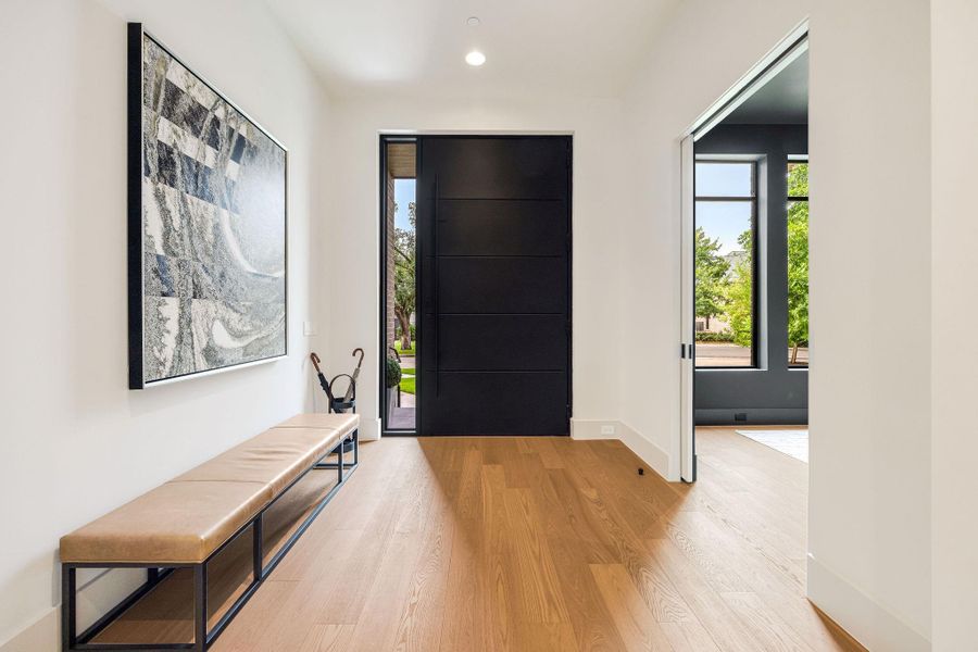 [FOYER] Welcome home to 4531 Elm, where the stunning entry foyer sets the tone with soaring 11-foot ceilings, rich wood flooring, and a bright, airy ambiance that is both refined and inviting.