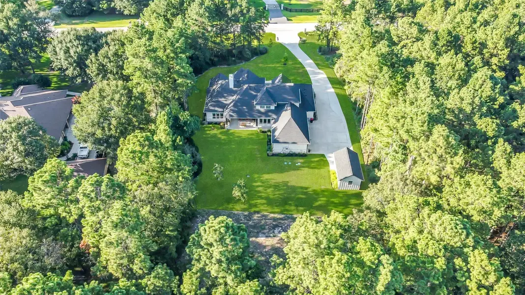 Bird's eye view overlooking the back of the home. The back approx 85 feet of property is a wooded reserve offering exceptional privacy and ambiance in the yard. Bird's eye view overlooking the back of the home. The back approx 85 feet of property is a wooded reserve offering exceptional privacy and ambiance in the yard.