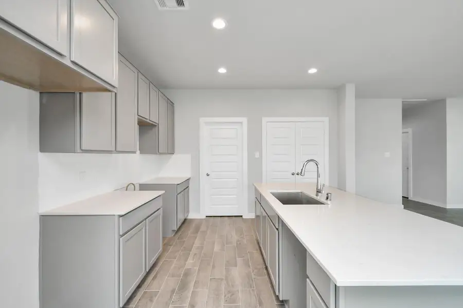 The extended counter area adds both practicality and style, making meal preparation a breeze. Every detail is thoughtfully designed to enhance the kitchen's functionality and aesthetic appeal. Sample photo of completed home with similar floor plan. Actual colors and selections may vary.