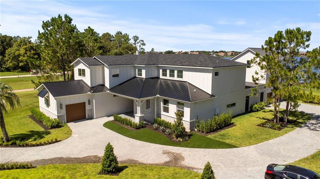 Front exterior of a new home in Windermere, Windermere, FL, highlighting curb appeal (Image 25).