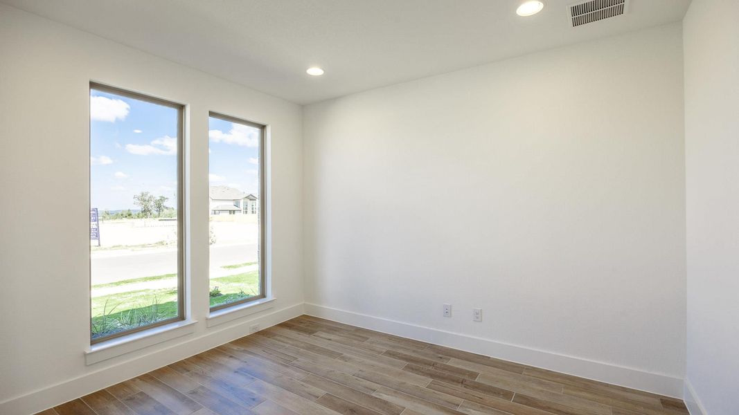 Empty room featuring recessed lighting and wood finished floors