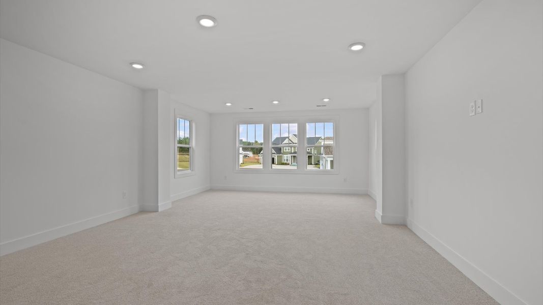 Exclusive upstairs retreat with a bright and airy primary suite with a walk-in closet