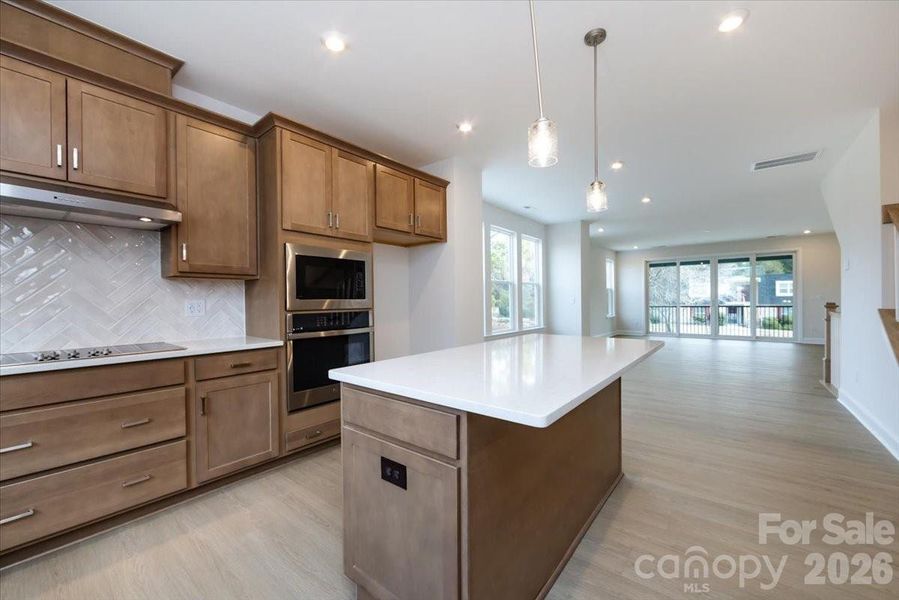 Warm brown cabinets with white quartz countertops