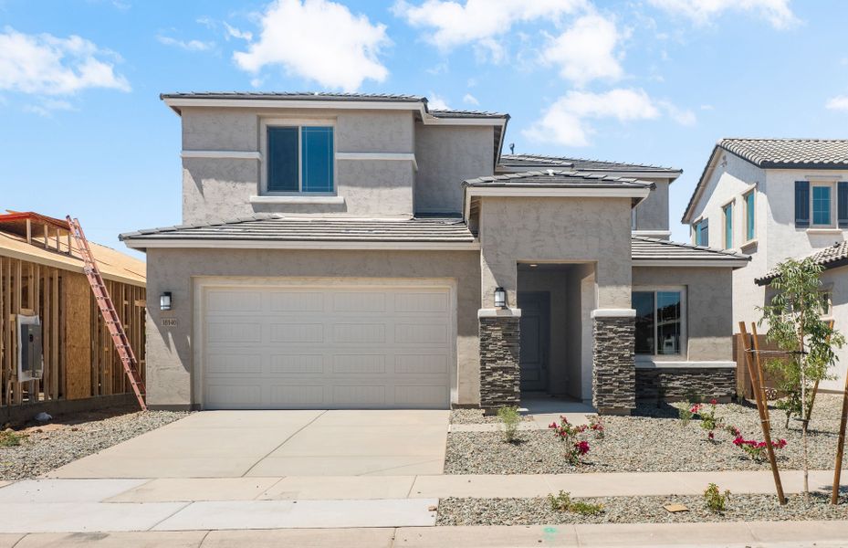 Front exterior of a new home in Legado West, Queen Creek, AZ, highlighting curb appeal (Image 2). Front exterior of a new home in Legado West, Queen Creek, AZ, highlighting curb appeal (Image 2).
