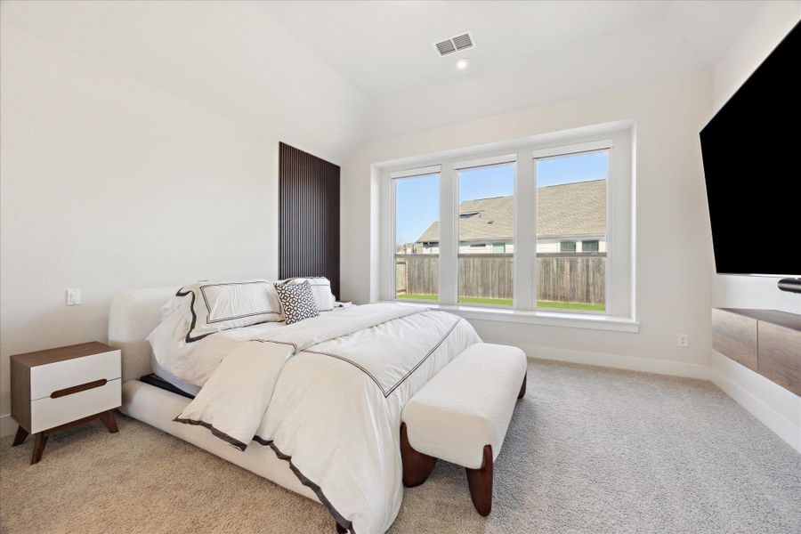 Large primary bedroom with blackout remote controlled blinds.