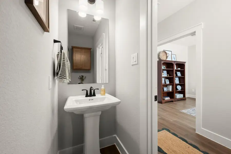 The downstairs half bath is perfectly placed for guests. The downstairs half bath is perfectly placed for guests.