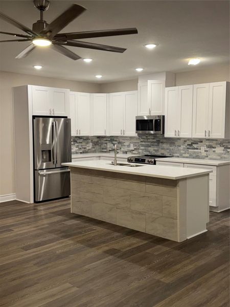 gorgeous kitchen with under mount sink, under cabinet lights, & stone back splash. Stainless steel appliances