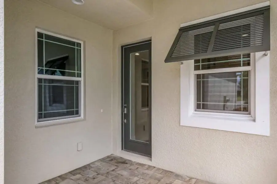 Exterior details and patio area of a home in Reflection Villas at Watercolor Place, Bradenton (Image 3).
