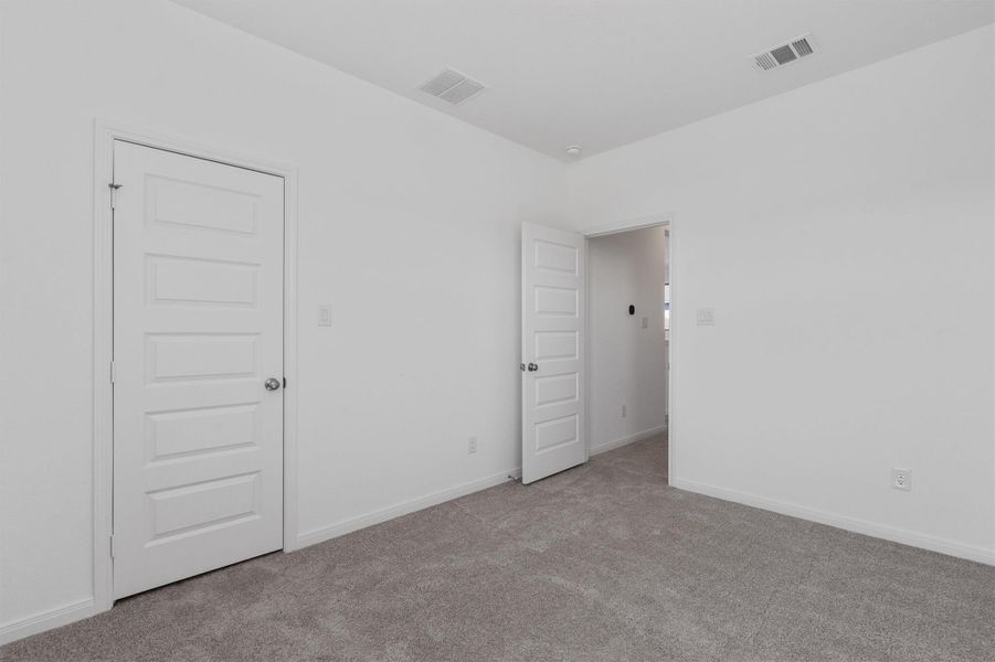 Unfurnished room with light carpet and baseboards