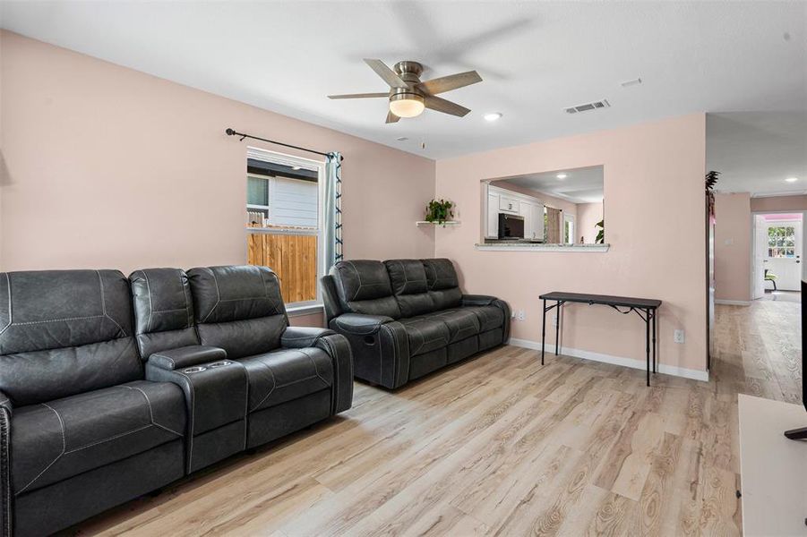 Living area featuring light wood-style floors, ceiling fan, and recessed lighting Living area featuring light wood-style floors, ceiling fan, and recessed lighting