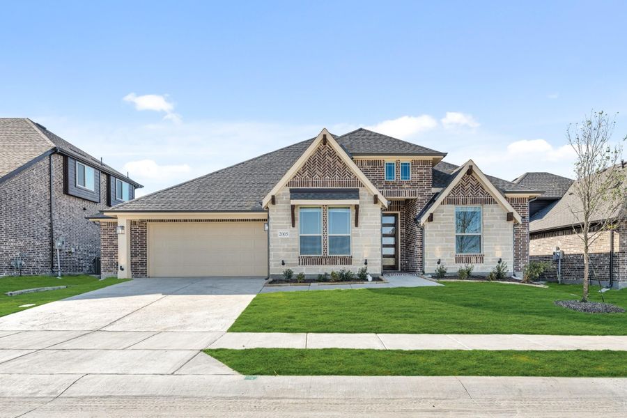 Single-story home with brick and stone exterior, two-car garage, and green front lawn Single-story home with brick and stone exterior, two-car garage, and green front lawn