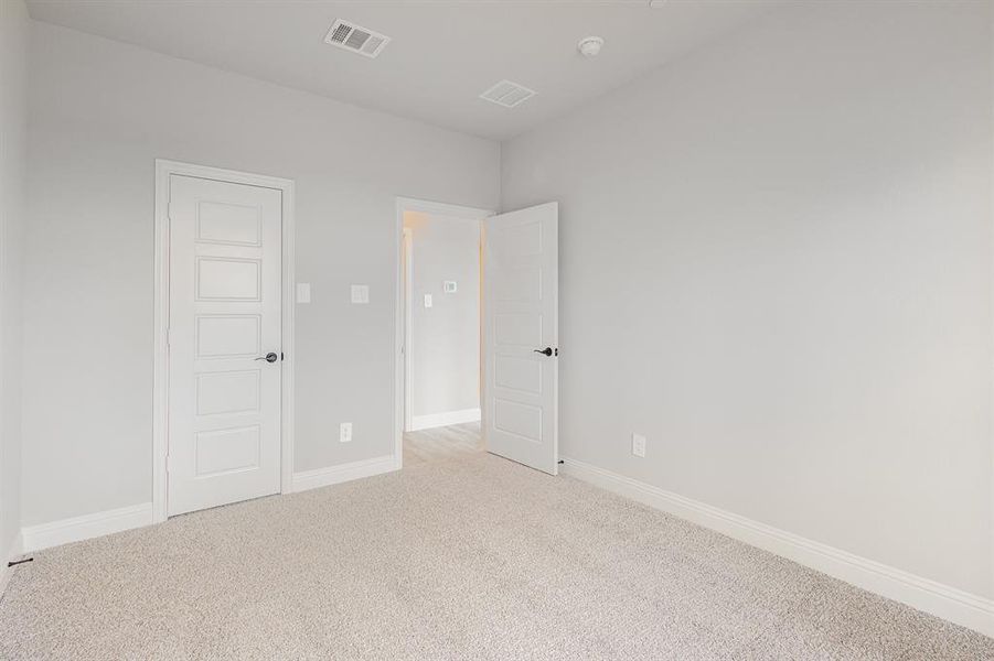 Unfurnished bedroom with baseboards and carpet flooring